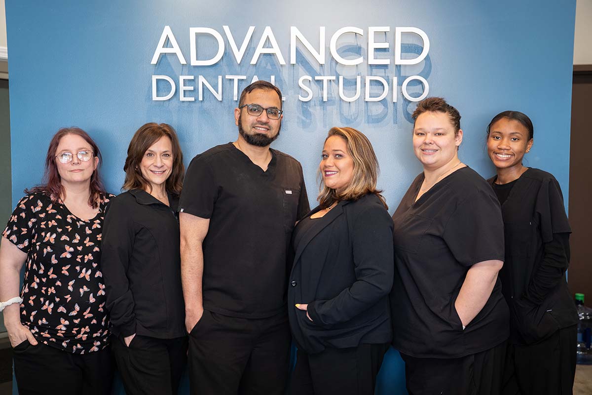 Frankfort Team in front of Advanced Dental Studio sign